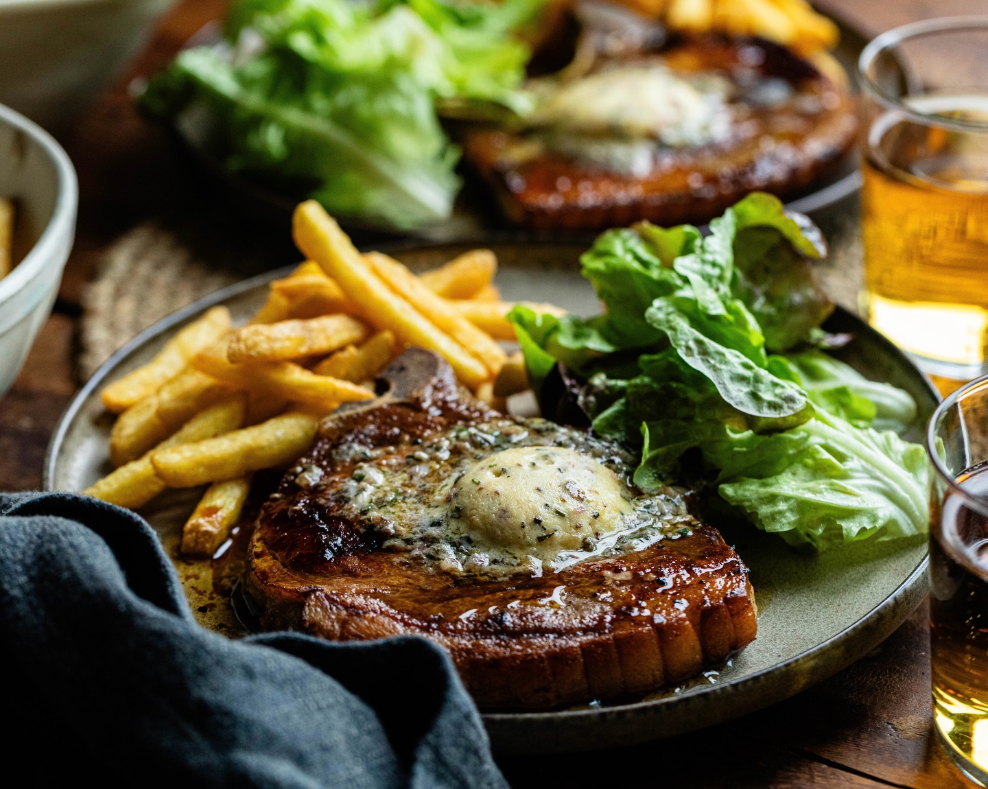Ask yourself this. When did you last have a really good pork chop?
This is why we keep coming back to it. Native, rare breed pork. Dry aged on the bone. Proper depth of flavour. Nothing like the pale, wet stuff you see elsewhere.
These are our Pork Chops with Rosemary and Anchovy Butter. Two thick, rindless chops. Two discs of handmade compound butter. Anchovy, rosemary, lemon zest, a little shallot. Old friends. It works.